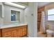 Bathroom with wood vanity, glass bowl sink, and tiled shower with mosaic accents at 748 Sagewood Dr, Lakeland, FL 33813