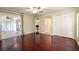 Spacious bedroom with wood floors, ceiling fan, closet, and sliding glass door to sunroom at 748 Sagewood Dr, Lakeland, FL 33813