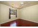 Bedroom with hardwood floors, ceiling fan, neutral walls and a sunlit window at 748 Sagewood Dr, Lakeland, FL 33813