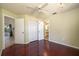 Bedroom featuring wood floors, neutral walls, closet, ceiling fan, and ensuite bath at 748 Sagewood Dr, Lakeland, FL 33813