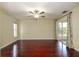 Bedroom featuring wood floors, a ceiling fan, a sliding glass door and bright natural light at 748 Sagewood Dr, Lakeland, FL 33813