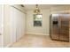 Bright dining area with tile flooring, a window view, and a stainless steel refrigerator at 748 Sagewood Dr, Lakeland, FL 33813