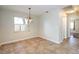 Cozy dining area featuring a chandelier, natural light from window, and tile flooring throughout at 748 Sagewood Dr, Lakeland, FL 33813