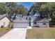 Well-maintained home with a two-car garage and mature trees in a beautiful neighborhood at 748 Sagewood Dr, Lakeland, FL 33813