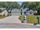 Exterior of a well-maintained home with a blue and white trim and mature trees at 748 Sagewood Dr, Lakeland, FL 33813