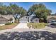 Charming single-story home boasts a well-manicured front lawn, attached garage, and beautiful landscaping at 748 Sagewood Dr, Lakeland, FL 33813