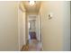 Hallway with neutral walls, tile flooring, and an open doorway to another room at 748 Sagewood Dr, Lakeland, FL 33813