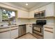 Well-equipped kitchen with stainless steel appliances, white cabinets, and a bright window at 748 Sagewood Dr, Lakeland, FL 33813