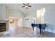 Spacious living area with a fireplace, ceiling fan, tile floors, and a piano, offering great living space at 748 Sagewood Dr, Lakeland, FL 33813