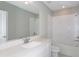 Well-lit bathroom featuring a soaking tub, tiled walls, and a vanity with a quartz countertop at 9060 Wildlight Trl, Wildwood, FL 34785