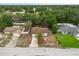 Aerial view of a single-Gathering home with driveway and mature tree in a residential neighborhood at 332 Sand Pine Trl, Winter Haven, FL 33880