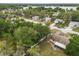 Aerial view of a tranquil residential neighborhood near a lake, showcasing tree-lined streets at 332 Sand Pine Trl, Winter Haven, FL 33880