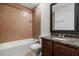 Cozy bathroom with granite countertop vanity, tiled walls, and shower-over-tub combo at 332 Sand Pine Trl, Winter Haven, FL 33880