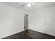 Empty bedroom with ceiling fan, hardwood floors, and closet with a partial view of the kitchen at 332 Sand Pine Trl, Winter Haven, FL 33880