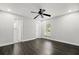 Bedroom with hardwood floors, ceiling fan, white walls, ensuite, and a closet at 332 Sand Pine Trl, Winter Haven, FL 33880
