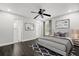 Staged bedroom featuring hardwood floors, neutral paint, ceiling fan, and decorative artwork at 332 Sand Pine Trl, Winter Haven, FL 33880