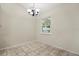 Bright dining area with tile flooring, neutral walls, and modern chandelier at 332 Sand Pine Trl, Winter Haven, FL 33880