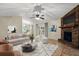Comfortable living room with brick fireplace, plush seating, and modern decor at 332 Sand Pine Trl, Winter Haven, FL 33880