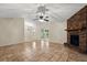 Inviting living space featuring a cozy brick fireplace and access to dining area at 332 Sand Pine Trl, Winter Haven, FL 33880