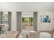 Bright living area featuring neutral walls, tile floors, and sliding glass doors at 332 Sand Pine Trl, Winter Haven, FL 33880