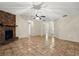 Spacious living room with a brick fireplace, neutral walls, and tile flooring at 332 Sand Pine Trl, Winter Haven, FL 33880