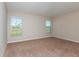 Bright bedroom with wall-to-wall carpeting and two large windows at 4015 Gardenia Ave, Lake Hamilton, FL 33851