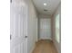 Well lit hallway with doors and hardwood flooring at 4015 Gardenia Ave, Lake Hamilton, FL 33851