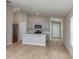 Modern open concept kitchen and living space with stainless steel appliances and hardwood floors at 4015 Gardenia Ave, Lake Hamilton, FL 33851
