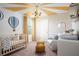 Charming Bedroom featuring a crib, soft lighting, and whimsical hot air balloon decor at 4027 Gardenia Ave, Lake Hamilton, FL 33851