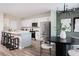 Open-concept kitchen with stainless steel appliances, island seating, and a dining area with a modern chandelier at 4027 Gardenia Ave, Lake Hamilton, FL 33851