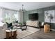 Bright living room featuring modern furniture, a patterned rug, large windows, and a contemporary accent wall at 4027 Gardenia Ave, Lake Hamilton, FL 33851