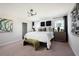 Comfortable main bedroom with plush carpet, stylish decor, large windows, and a modern chandelier at 4027 Gardenia Ave, Lake Hamilton, FL 33851