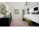 Spacious main bedroom with carpet, artwork, large windows, and modern furniture at 4027 Gardenia Ave, Lake Hamilton, FL 33851