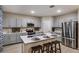 Contemporary kitchen with gray cabinets, stainless steel appliances, quartz countertops, and an island with seating at 4039 Gardenia Ave, Lake Hamilton, FL 33851