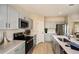 Bright kitchen with sleek gray cabinetry, stainless steel appliances, and quartz countertops at 4039 Gardenia Ave, Lake Hamilton, FL 33851