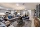 Open-concept living area with modern furnishings, light-colored floors, and seamless flow to kitchen and dining areas at 4039 Gardenia Ave, Lake Hamilton, FL 33851