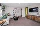 Cozy living room featuring a modern entertainment center, stylish decor, and a comfortable gray sofa with colorful pillows at 4039 Gardenia Ave, Lake Hamilton, FL 33851
