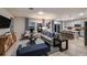 Open-concept living room with stylish furnishings, decorative curtains and an adjacent kitchen island with breakfast bar at 4039 Gardenia Ave, Lake Hamilton, FL 33851