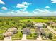 Aerial view of a residential neighborhood showcasing lush greenery, well-maintained homes, and beautiful landscaping at 421 Sierra Mike Blvd, Lake Alfred, FL 33850