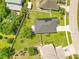 Aerial view of a home with a spacious, green backyard, a well-maintained roof, and a paved driveway at 421 Sierra Mike Blvd, Lake Alfred, FL 33850