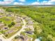 Lush residential area featuring well-spaced houses, a serene pond, and abundant greenery, ideal for a peaceful lifestyle at 421 Sierra Mike Blvd, Lake Alfred, FL 33850