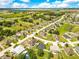 Picturesque aerial image showcasing a tranquil residential neighborhood with tree-lined streets, interspersed with scenic lakes at 421 Sierra Mike Blvd, Lake Alfred, FL 33850