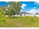Expansive backyard with a privacy fence, mature trees, and ample space for outdoor enjoyment at 421 Sierra Mike Blvd, Lake Alfred, FL 33850