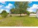 Large backyard featuring healthy lawn, shade trees, and plenty of room for activities at 421 Sierra Mike Blvd, Lake Alfred, FL 33850