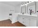 Spacious bathroom with double sinks, modern vanities, and a large soaking tub at 421 Sierra Mike Blvd, Lake Alfred, FL 33850