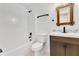 Bathroom with a shower-tub combo, modern vanity, and neutral tile, creating a relaxing space at 421 Sierra Mike Blvd, Lake Alfred, FL 33850