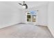 Bright bedroom features a ceiling fan and a large window, with outside views at 421 Sierra Mike Blvd, Lake Alfred, FL 33850