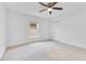 Bright bedroom featuring neutral carpet, white walls, closet, and a ceiling fan at 421 Sierra Mike Blvd, Lake Alfred, FL 33850
