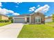 Charming single-story home with stone accents, well-manicured lawn, and attached two-car garage at 421 Sierra Mike Blvd, Lake Alfred, FL 33850