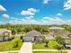 Charming single-story home with a well-manicured lawn, stone accents, and an attached two-car garage at 421 Sierra Mike Blvd, Lake Alfred, FL 33850